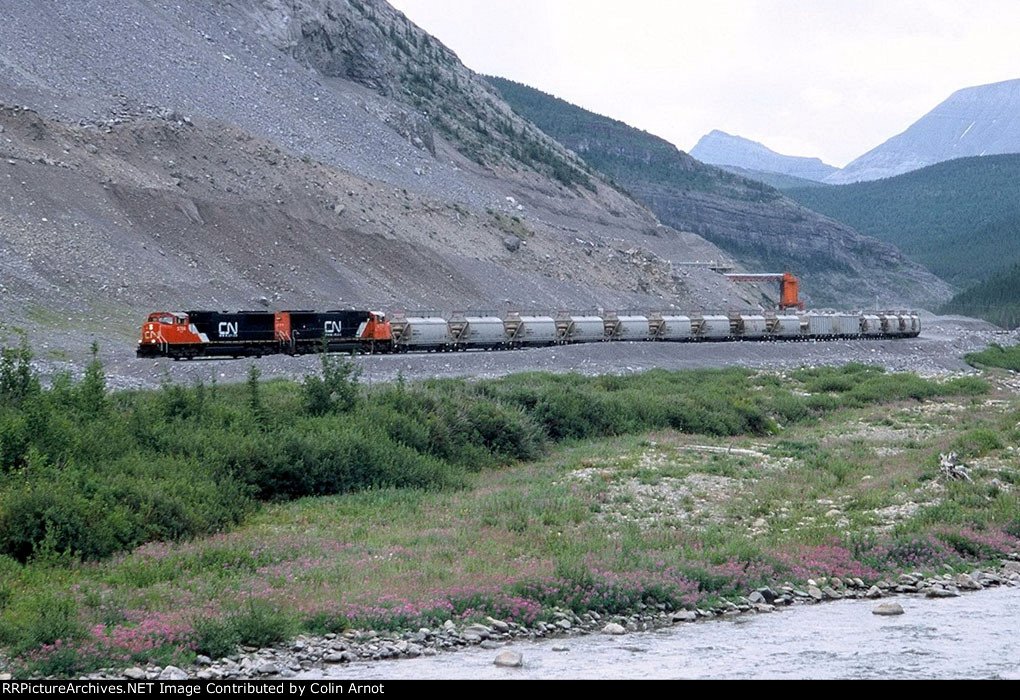 CN 5704 and 5777 depart Cadomin with loaded limestone cars headed for